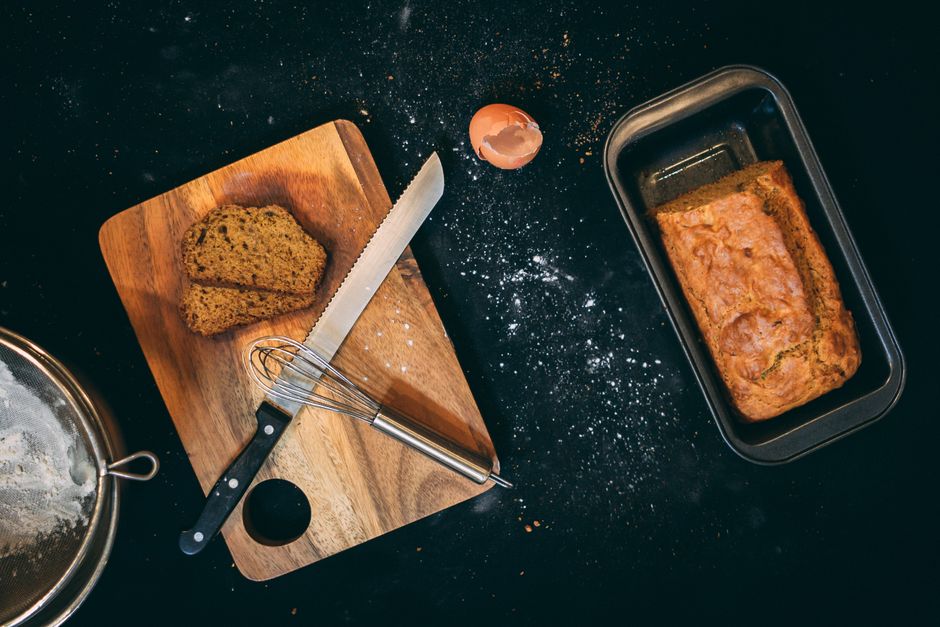 A beautiful slice of warm gluten-free banana bread with steam rising and melted butter on top