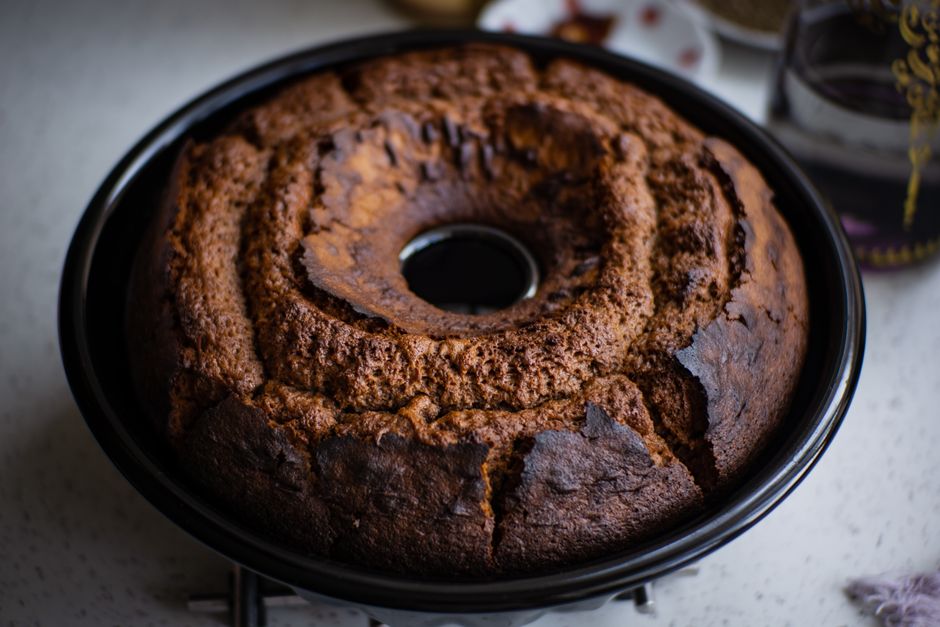 The Ultimate Chrissy Teigen Banana Bread Recipe: A Decadent Twist on a Classic 1 A freshly baked, golden brown banana bread in a bundt pan, sliced to show chocolate chunks and coconut flakes inside