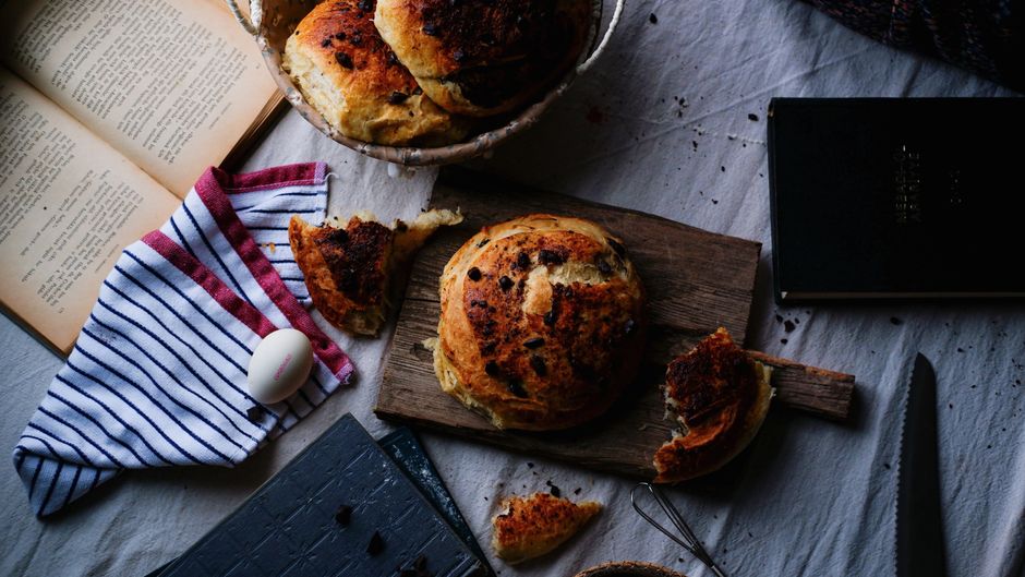 Healthy Chocolate Chip Banana Bread Recipe - Moist & Wholesome 1 A freshly baked loaf of healthy chocolate chip banana bread sitting on a wooden cutting board, sliced to reveal melted chocolate chips and a moist crumb structure.