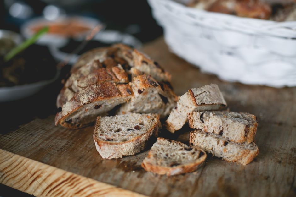Ultimate Sourdough Discard Banana Bread Recipe: Moist & Tangy 1 A freshly baked loaf of sourdough discard banana bread sliced on a wooden cutting board with steam rising