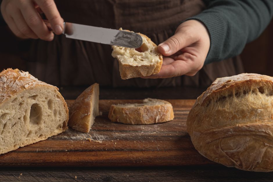 Easy Bisquick Recipe for Banana Bread: Moist & Quick Baking Guide 2 A slice of banana bread spread with a melting pat of butter, showing the soft, airy texture of the crumb.