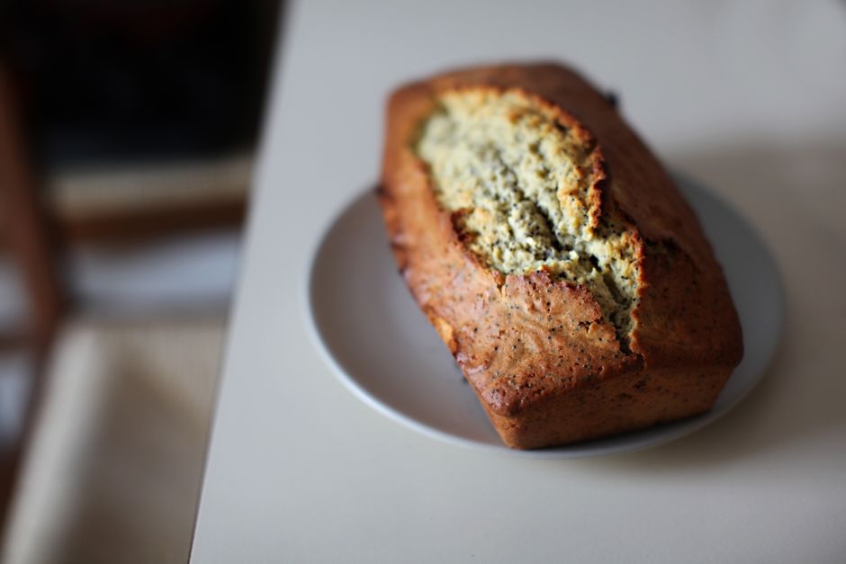 One Banana Banana Bread Recipe: The Ultimate Small-Batch Guide 3 A slice of warm one banana banana bread topped with a melting pat of butter on a blue ceramic plate