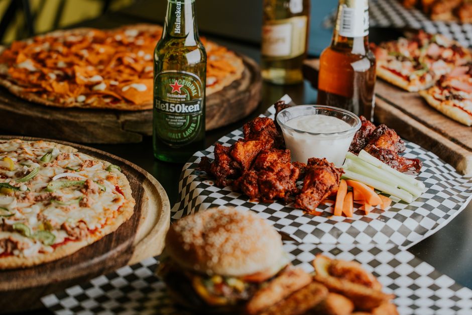 Sports Page Ashland Menu: The Ultimate Dining Guide & Copycat Recipe 2 A spread of delicious sports bar food, including wings, fries, and burgers