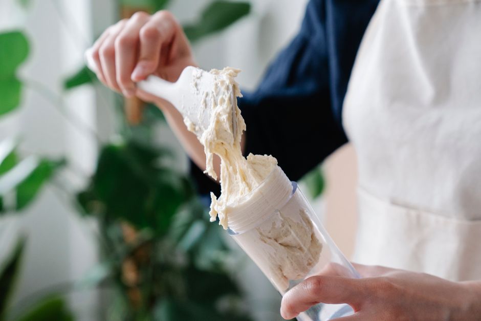 The Ultimate Banana Bread Frosting Recipe: Creamy, Decadent, and Easy 2 Close-up of cream cheese frosting being swirled onto a cooled banana bread loaf using a metal offset spatula