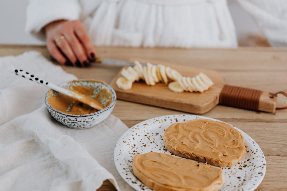 Moist Banana and Peanut Butter Bread Recipe - The Ultimate Comfort Bake 2 Close-up of ripe, brown-speckled bananas next to a jar of creamy peanut butter and a bowl of brown sugar