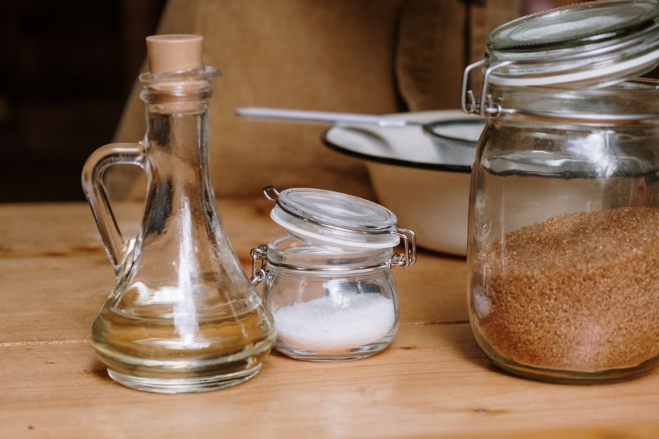 Best Banana Bread Recipe with Oil: The Ultimate Moist & Fluffy Guide 2 Different types of baking oils in small glass jars next to ripe, speckled bananas