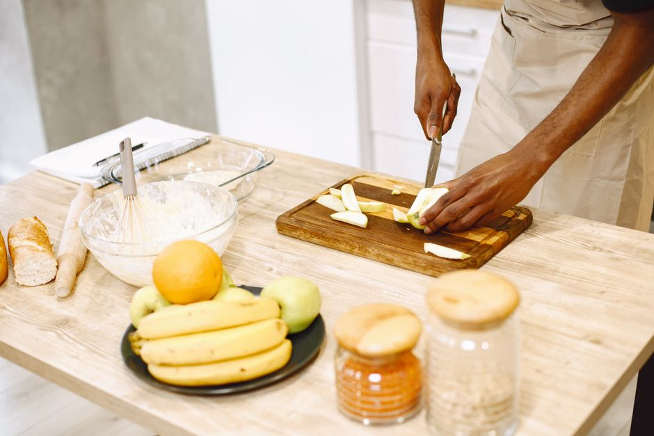 Healthy Banana Bread Recipe with Oats: Easy, Moist, and Naturally Sweet 2 Hands mashing ripe bananas in a glass bowl with a fork, with measuring cups of rolled oats and spices nearby