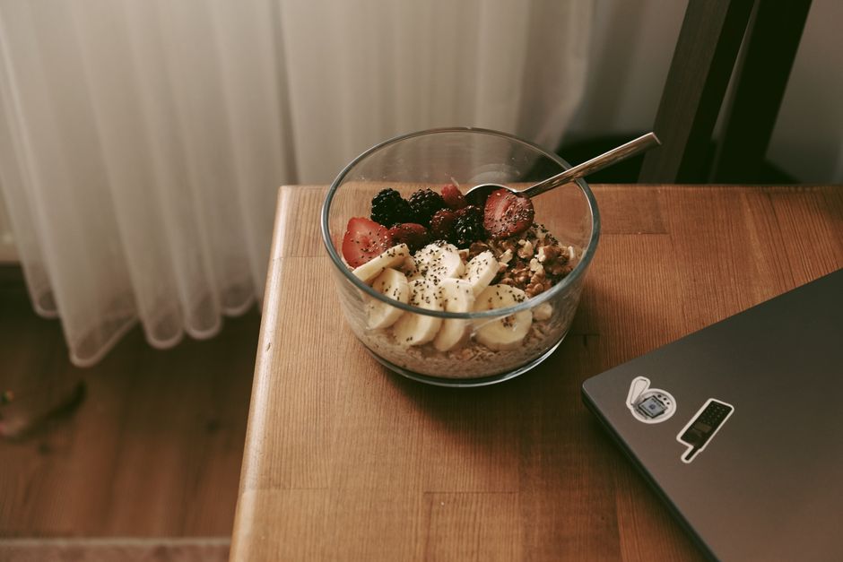 Mixing bowl with mashed bananas, oats, and walnuts