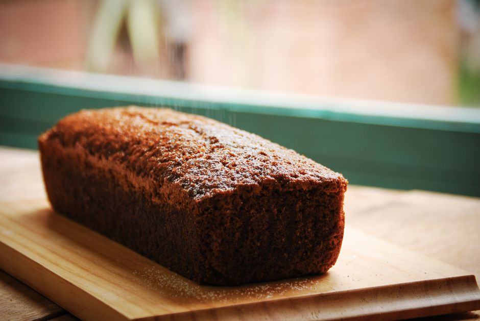 Slices of chocolate chip banana bread loaf arranged on a wooden serving board