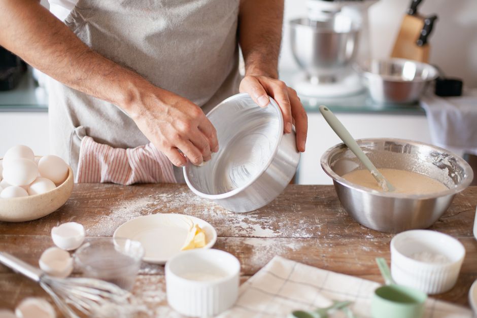 Moist Banana Bread Recipe Without Milk: The Ultimate Dairy-Free Guide 3 The batter being poured into a greased loaf pan, showing a rich, speckled texture.